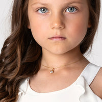 Young Girl wearing a Sparkle Heart Pendant and Necklace in yellow gold vermeil, wearing a white flower girl dress