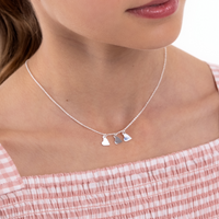 Three of Hearts Necklace worn by a Teen in pink and white dress